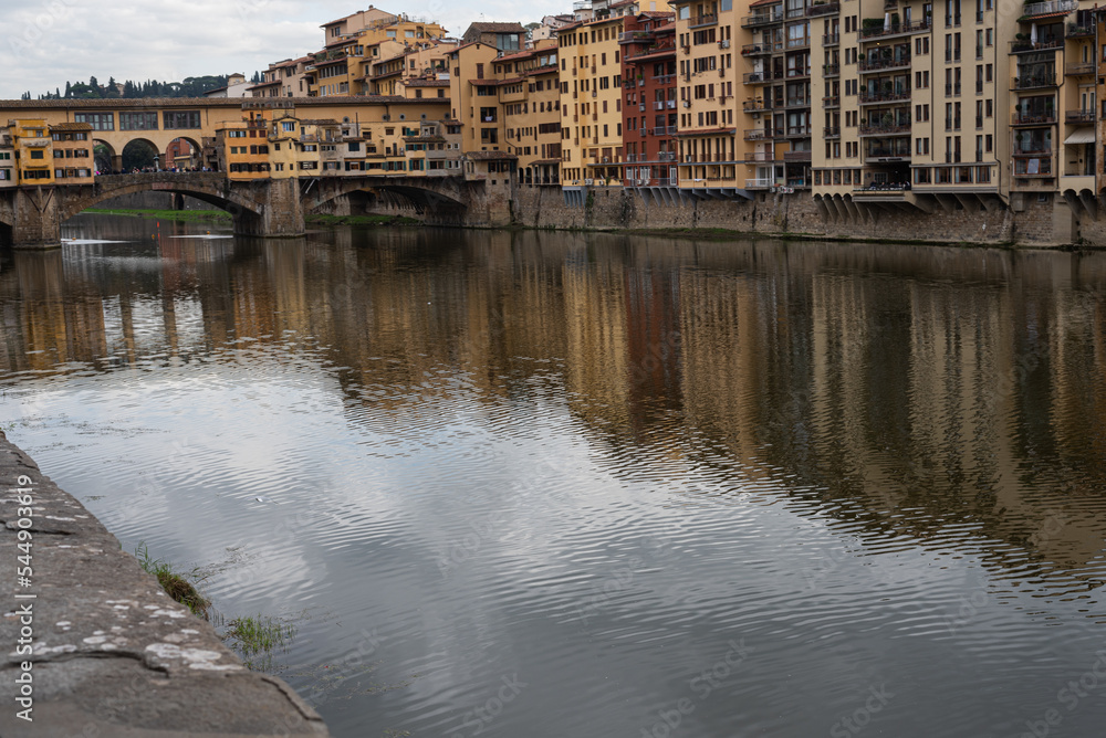 Bridge over the river Arno. Bank of the river Arno in Florence, Italy. Reflection. 