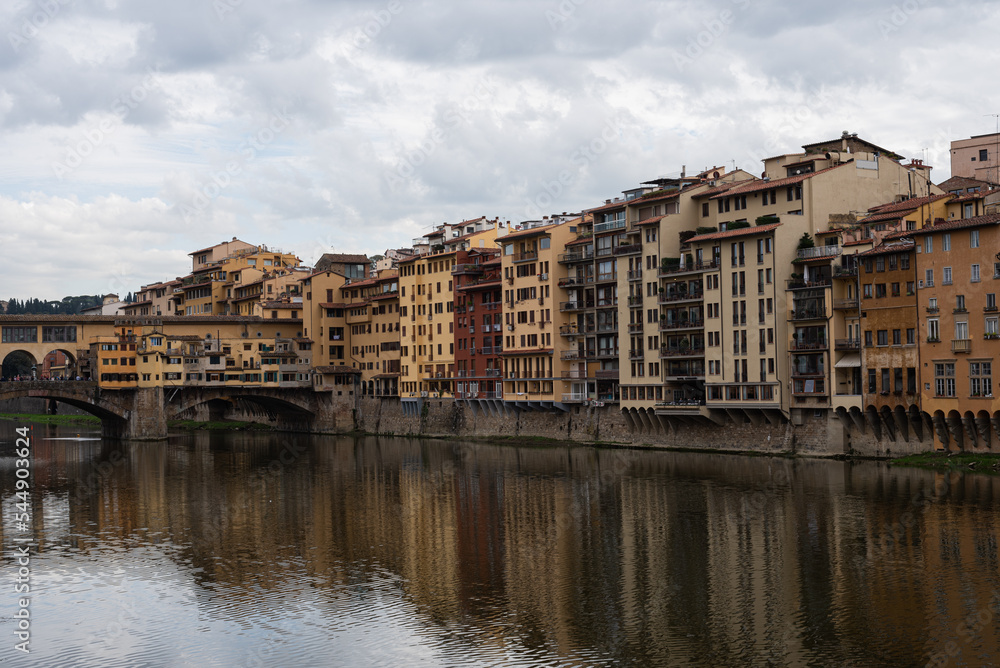 Bridge over the river Arno. Bank of the river Arno in Florence, Italy. Reflection. 