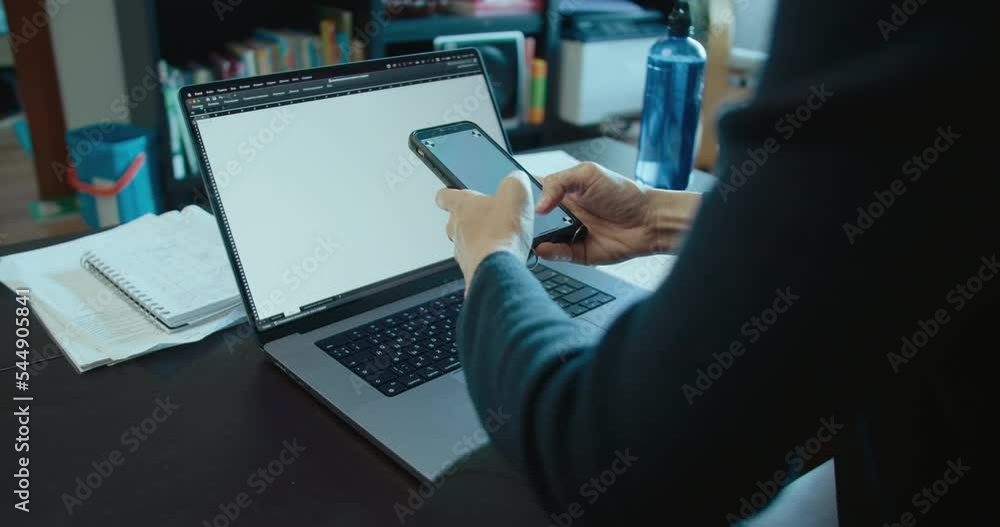 Freelancer woman work at home use laptop computer and smartphone in living room Freelancer woman work at home use laptop computer and smartphone in living room