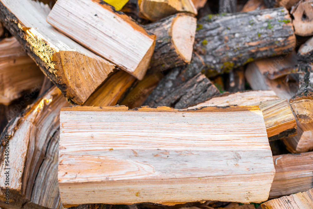 A pile of firewood chopped close-up for heating a house in the countryside A pile of firewood chopped close-up for heating a house in the countryside