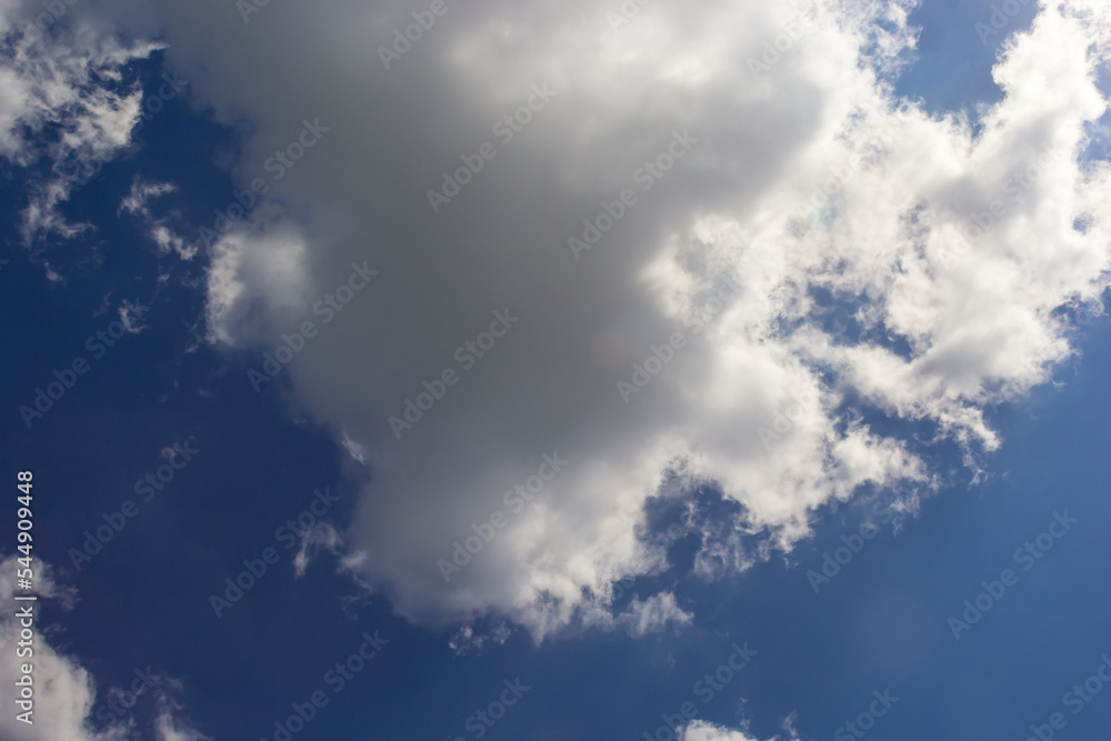 clouds in the sky lit by the sun on a summer day. background clouds in the sky lit by the sun on a summer day. background