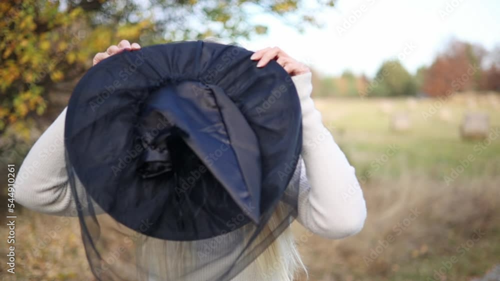 woman with witch hat in fall scene woman with witch hat in fall scene