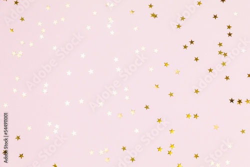 Photography Gold sparkle confetti stars on a pink pastel background