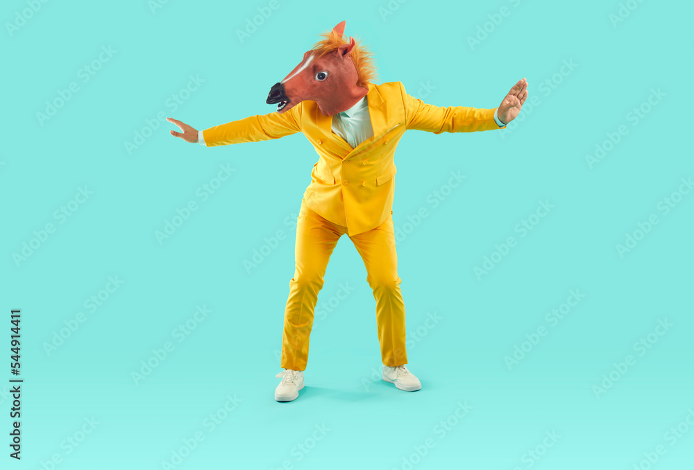 Funny man in bizarre carnival costume dancing and having fun. Happy guy