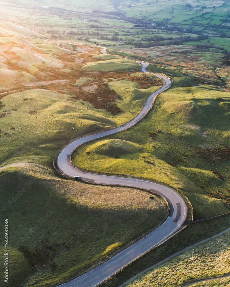 Winding road snaking through green fields Winding road snaking through green fields