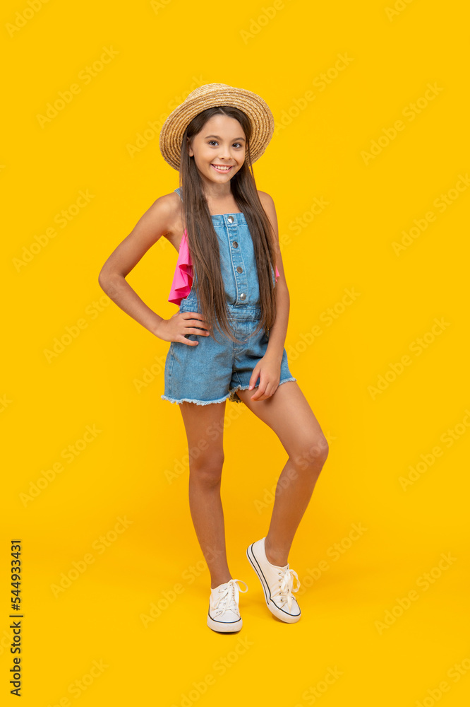 smiling teen girl in straw hat standing on yellow background smiling teen girl in straw hat standing on yellow background