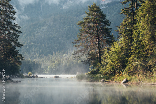 Beautiful misty morning on Eibsee, Oberammergau. Bavaria, Germany. Zugspitze Mountain in background