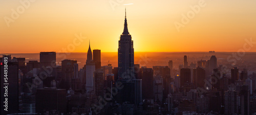 Manhattan Skyline Empire State at sunrise, beautiful morning glow with warm sun, Silhouette 