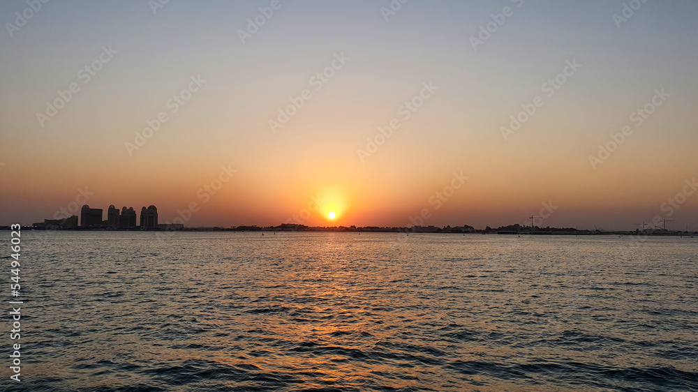 beautiful sunset over the sea. City line of Doha, Qatar, Gulf region