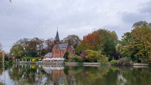 old church, vintage castle, beautiful architecture in the city, building near park with trees and river. Town in Europe 