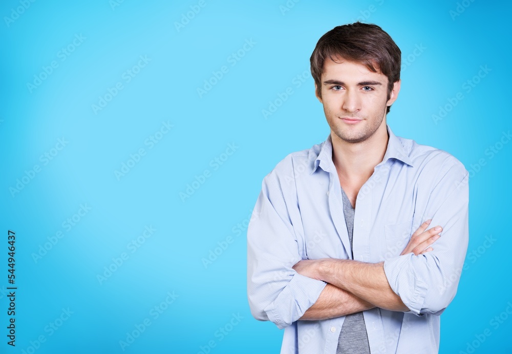 Happy handsome young male posing hands folded