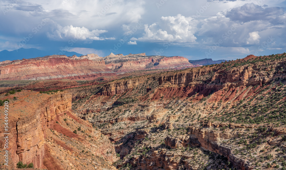 Dramatic evening lighting on the canyon from Sunset Point at the Capitol Reek National Park mountains in the distance Dramatic evening lighting on the canyon from Sunset Point at the Capitol Reek National Park mountains in the distance