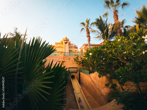 Dubai, United Arab Emirates - 13th october, 2022: visitor take most famous slide in Atlantis water park Neptune tower. Popular fun tourist attraction in Dubai, United Arab Emirates photo