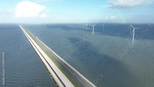 The Afsluitdijk flood defense system in the Netherlands between North Holland and Friesland closing the IJsselmeer off from the Wadden Sea. Dam and road infrastructure aerial drone view. photo