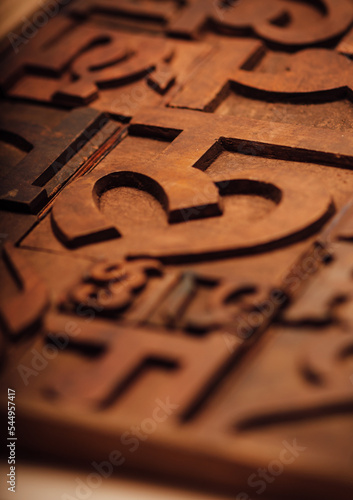 Weathered wooden alphabets of an Indian language. Traditional letter press printing blocks background.