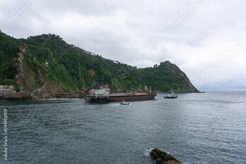 Ship being dragged out to sea in Pasaia Spain photo