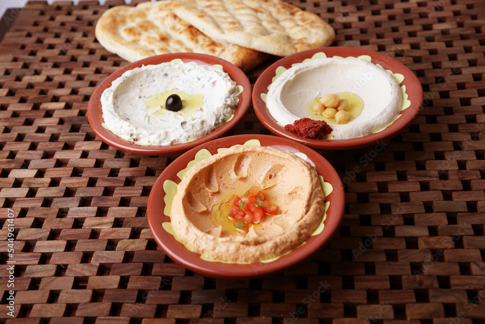 mixed hummus with bread served in dish isolated on table side view of middle east food mixed hummus with bread served in dish isolated on table side view of middle east food