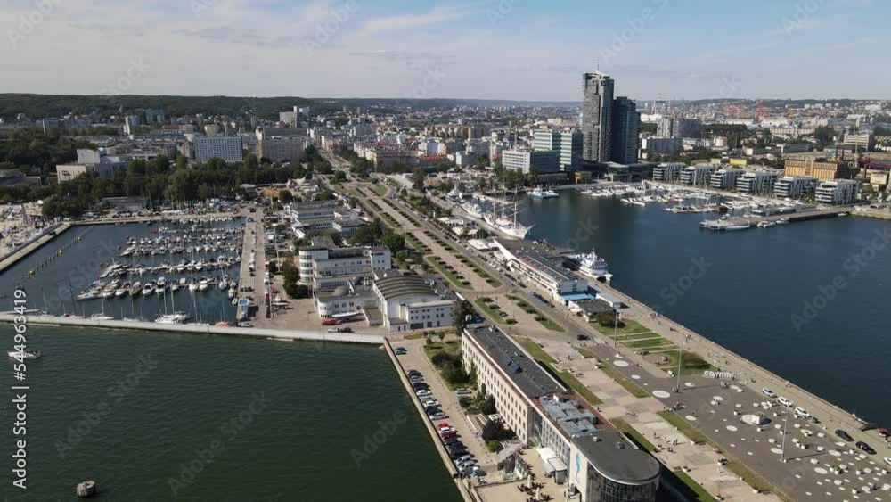 View from the top of the Port of Gdynia ,ships and sailing ships at the quay ,Kosciuszko Square and a breakwater on a summer,sunny day. View from the top of the Port of Gdynia ,ships and sailing ships at the quay ,Kosciuszko Square and a breakwater on a summer,sunny day.