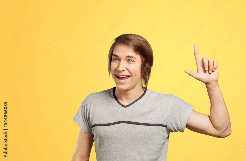 Happy young man pointing with finger Happy young man pointing with finger
