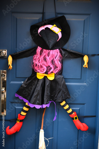 Witch on the door of the house as Halloween decoration.