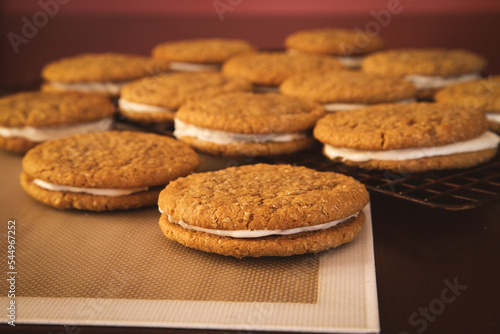 Horizontal color image of oatmeal cream pies with a cooling rack