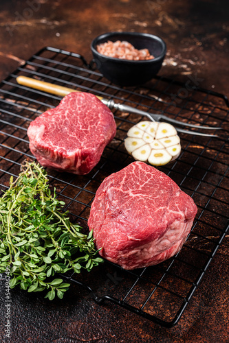 Raw Fillet Mignon Beef steaks, Dry aged tenderloin meat. Dark background. Top view