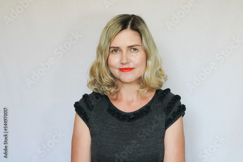 Beautiful middle-aged blond woman on a white background