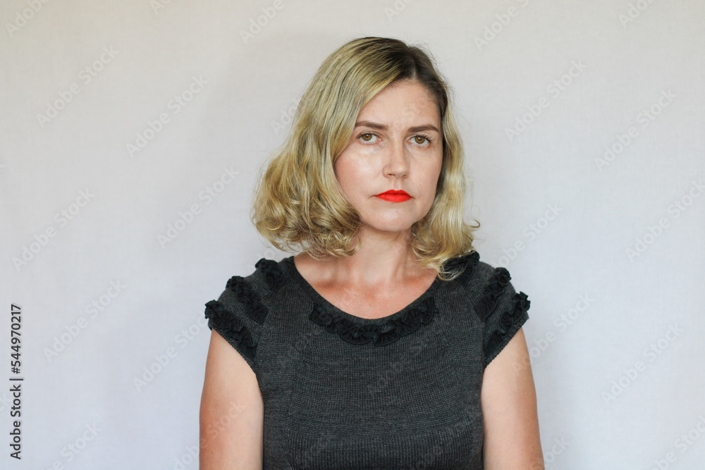 Beautiful middle-aged blond woman on a white background Beautiful middle-aged blond woman on a white background