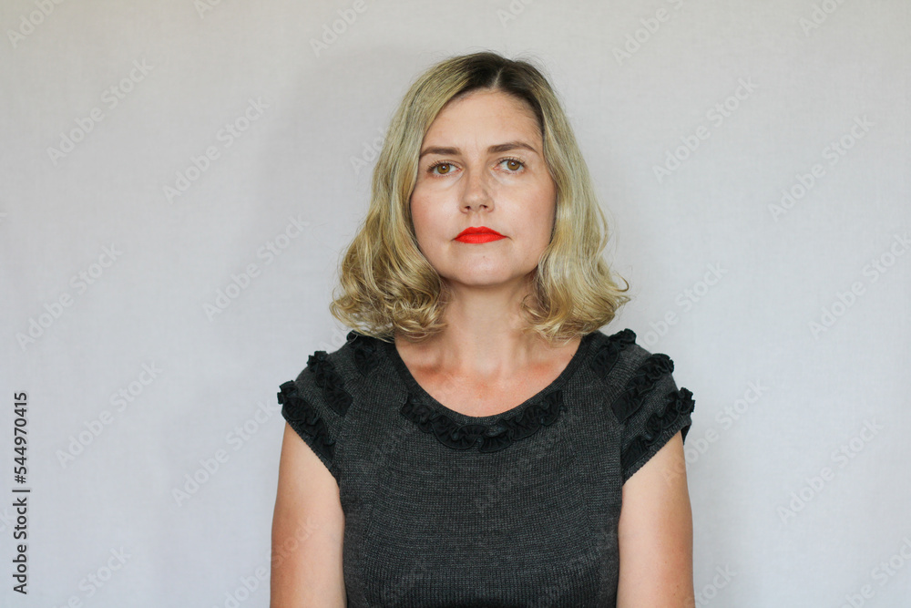 Beautiful middle-aged blond woman on a white background Beautiful middle-aged blond woman on a white background