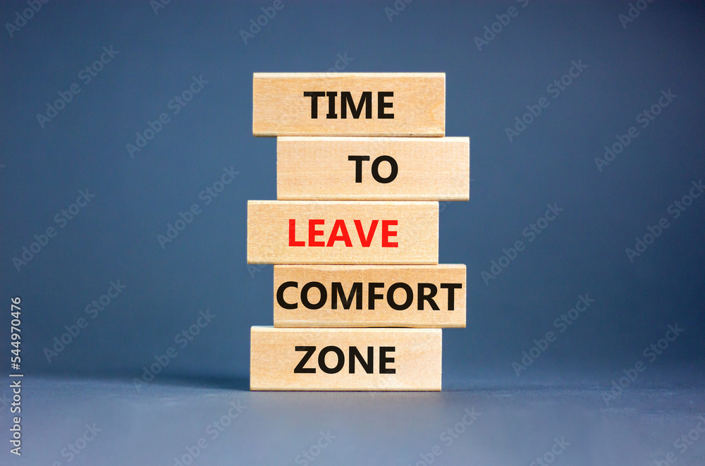 Leave comfort zone symbol. Concept words Time to leave comfort zone on wooden blocks. Beautiful grey table grey background. Business time to leave comfort zone concept. Copy space.