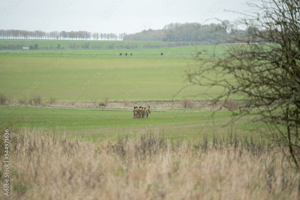 a group of British army soldiers stood planning action in a field on a military exercise, Wilts UK a group of British army soldiers stood planning action in a field on a military exercise, Wilts UK