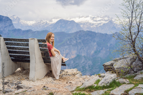 Woman tourist on background of Breathtaking panoramic view of the Grlo Sokolovo gorge in Montenegro. In the foreground is a mountain, the flat side of which forms a cliff, and the ridge is overgrown photo