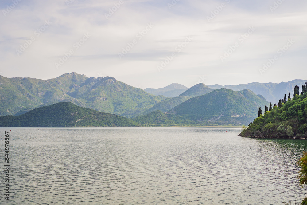 Fototapeta premium National Park Skadar Lake. Montenegro. Skadar lake. Dawn. View from above. The largest lake in the Balkans. Mountains of the Dinaric Highlands. Swampy shores and colorful vegetation of Skadar Lake