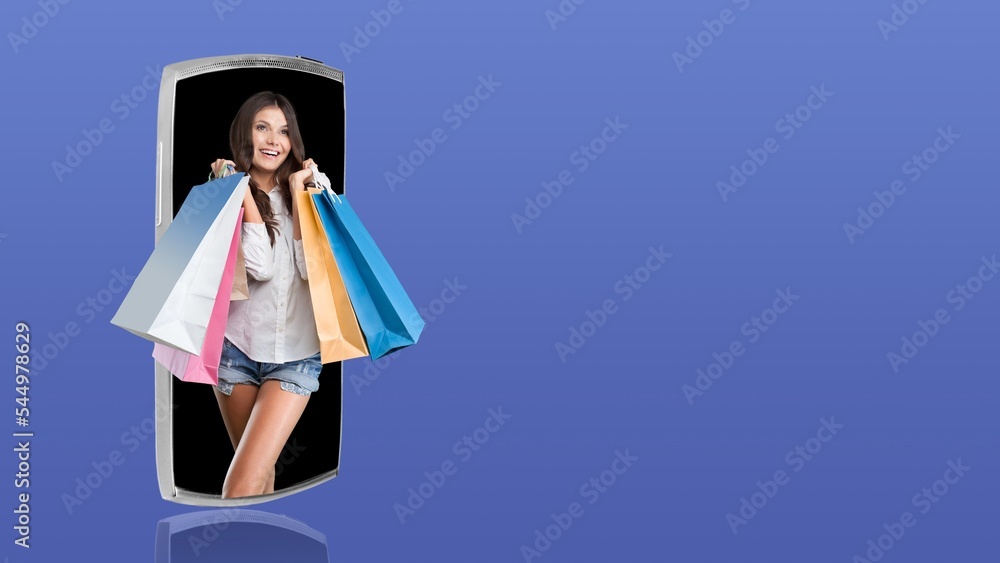 Happy woman with set of bags on the smartphone screen