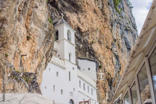 Monastery of Ostrog, Serbian Orthodox Church situated against a vertical background, high up in the large rock of Ostroska Greda, Montenegro. Dedicated to Saint Basil of Ostrog photo