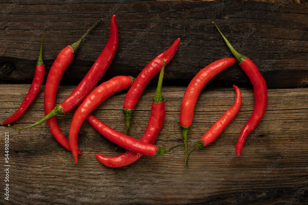 Hot chili pepper on a wooden background.