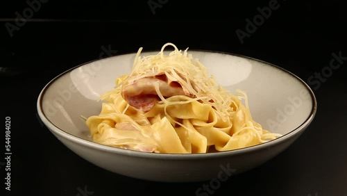 Pasta with bacon and cheese in a bowl. photo