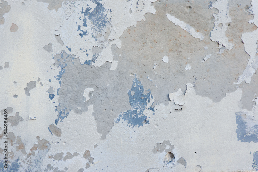 White grunge old concrete stucco wall texture background. Abstract weathered peeled plaster wall with falling off flakes of paint background White grunge old concrete stucco wall texture background. Abstract weathered peeled plaster wall with falling off flakes of paint background