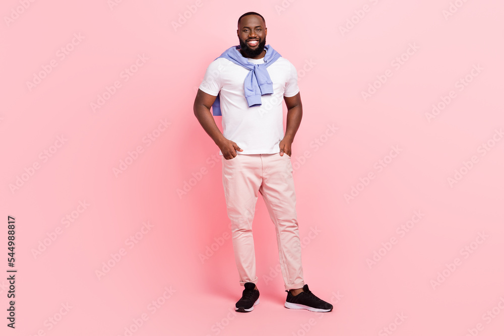 Full body image of young good looking groomed man waiting for his girlfriend isolated on pink color background Full body image of young good looking groomed man waiting for his girlfriend isolated on pink color background