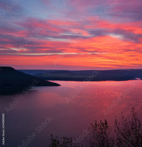 Sunset view of Bakota Bay with pink sky and water on dusk. Khmelnytskyi regio...