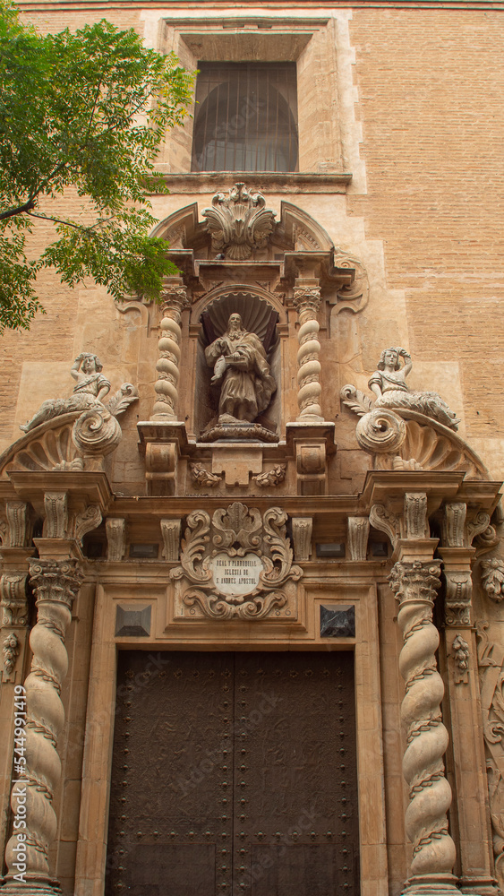 Facade and door of an old church in the city of Valencia (Spain)