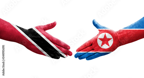 Handshake between North Korea and Trinidad Tobago flags painted on hands, isolated transparent image.