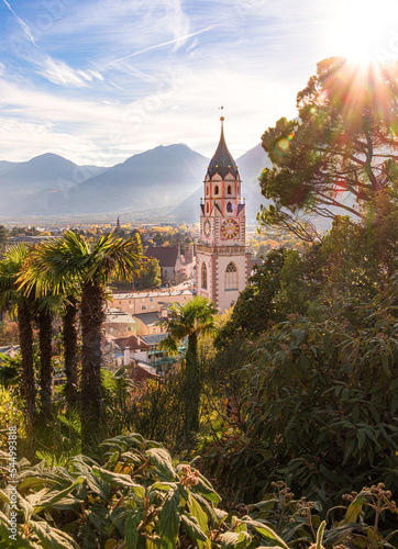 View over cityscape with Cathedral Saint Nikolaus of Merano, South tyrol, Italy seen from famous hiking trail Tappeinerweg
