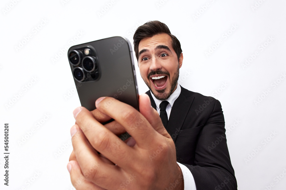 Business man himself on the phone taking a selfie with a smile with teeth happy communicating via video call online in a business suit on a white isolated background close-up on a wide angle lens Business man himself on the phone taking a selfie with a smile with teeth happy communicating via video call online in a business suit on a white isolated background close-up on a wide angle lens
