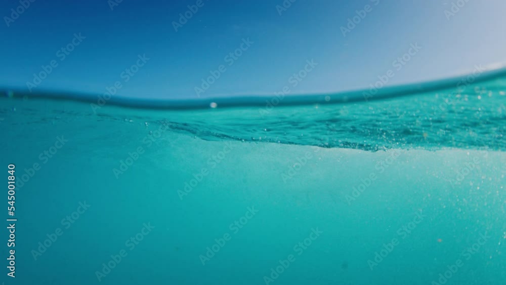 Amateur surfer rides the wave. Water view of the male surfer riding the crystal clear wave in the Maldives Amateur surfer rides the wave. Water view of the male surfer riding the crystal clear wave in the Maldives