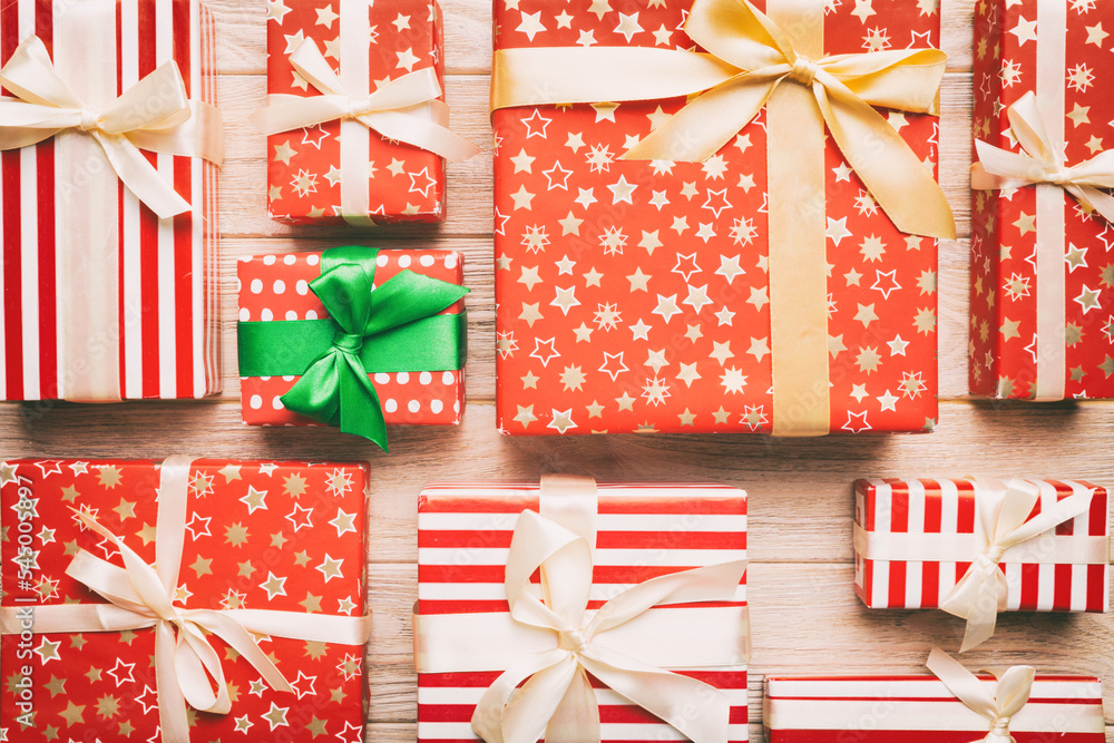 A lot of Christmas gift boxes in colored paper decorated on table, Top view close up. Many present New Year gift A lot of Christmas gift boxes in colored paper decorated on table, Top view close up. Many present New Year gift