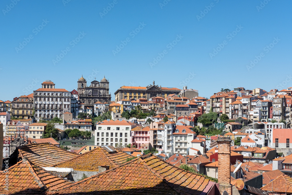 Ample views from the lookout Terreiro da Se, near the famous Romanesque cathedral, towards historical buildings, churches and the traditional colorful rooftops in Porto, Portugal