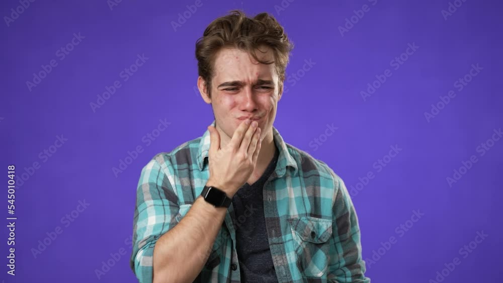 Portrait of young hipster man 20s with tooth dental ache pain problem in mouth isolated on purple background in studio Portrait of young hipster man 20s with tooth dental ache pain problem in mouth isolated on purple background in studio