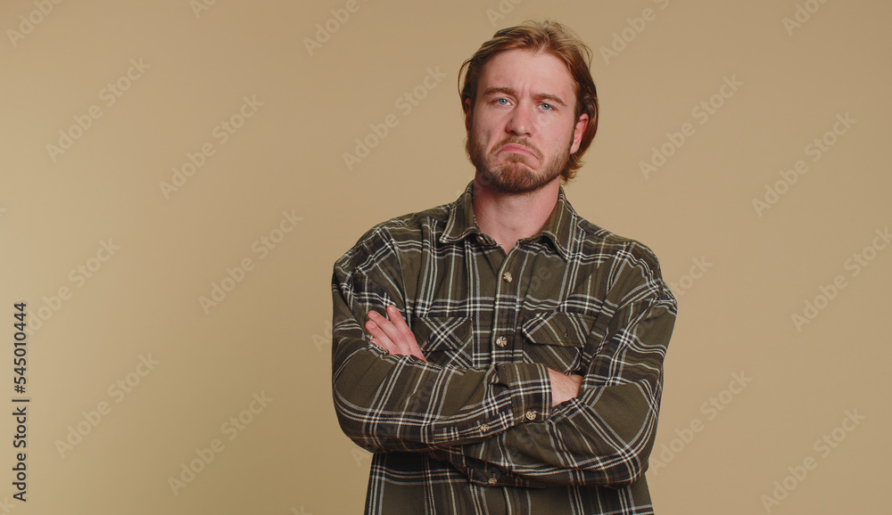 Dissatisfied man shaking head no, asking reason of failure, expressing disbelief irritation, feeling bored, disappointed in result, bad news. Adult guy isolated alone on beige studio wall background Dissatisfied man shaking head no, asking reason of failure, expressing disbelief irritation, feeling bored, disappointed in result, bad news. Adult guy isolated alone on beige studio wall background