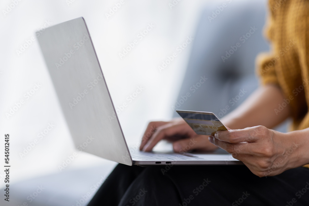Close up of woman hand using credit card and laptop for payment and online shopping, Online shopping, payments digital banking, E-commerce concept. Close up of woman hand using credit card and laptop for payment and online shopping, Online shopping, payments digital banking, E-commerce concept.